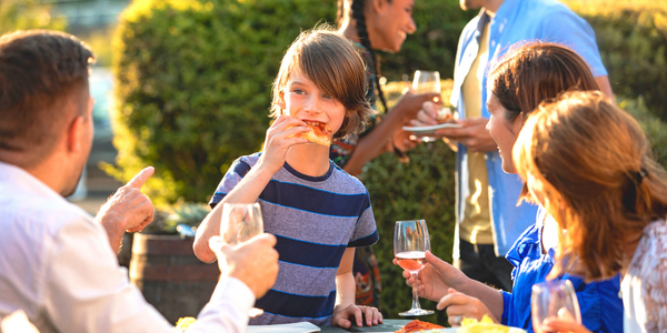 Why Creating A Great Support System Is Important For Families Of Children With Short Bowel Syndrome - Eclipse Regenesis Blog Image1 Family and friends eat together outside.